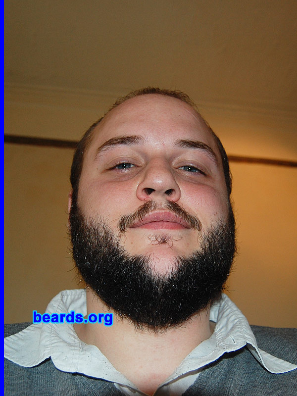 Will
Bearded since: 2008.  I am an experimental beard grower.

Comments:
I grew my beard because it mainly comes down to a necessity to prove one's manliness. The second reason was to see if I could, which I think I can, except for the part of my chin, which refuses to partake.

How do I feel about my beard? I like it; as opposed to the hair on my head, it is full and thick. The random ginger and gray hairs baffle me, except that I think the character of a beard comes through from its own diversity in how it develops.
Keywords: full_beard