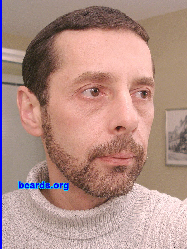 Rob L.
Bearded since: December 2007.  I am an experimental beard grower.

Comments:
I grew my beard because I've always liked a stubble appearance.

How do I feel about my beard?  So.. here is my beard at three weeks. I've been defying the advice not to trim it since I wanted something really short (but longer than stubble) -- basically, what you see here in this photo, though I'll let it grow just a bit more. It's been an interesting experience.  I had no idea that gray hairs grow so much faster than anything else (or is it my imagination?); or that a well-kept beard can be a lot of work (Kudos to all you great beard growers out there.  I admire your commitment!).
Keywords: full_beard