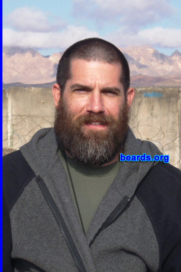 Kevin
Bearded since: 2011. I am a dedicated, permanent beard grower.

Comments:
I grew my beard to blend in with the landscape while serving in Afghanistan. The wife loves it and hopes to see it grow much longer.

How do I feel about my beard? I wish the gray hairs were not there, but hey I earned them. Society must understand that not everyone can grow a full beard. One thing is for sure, a beard is like a set of deer antlers; the bigger the more impressive! 
Keywords: full_beard