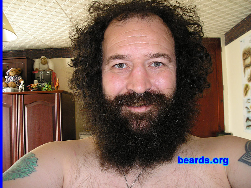 Dave C.
Bearded since: about 1995.  I am a dedicated, permanent beard grower.

Comments:
I grew my beard simply because I wanted a different look from the crowd.

How do I feel about my beard? Fine. I've grown my hair quite long and I feel the rough, thick, and full beard goes with it better than any type of sculpted look would. It became more and more comfortable as it grew. The only real cutting I do to it is trim the lower level of the mustache simply for ease of eating and drinking. This doesn't have to be done often anyway.
Keywords: full_beard