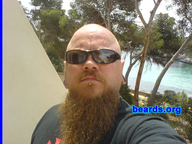 Stumpy
Bearded since: 1990.  I am a dedicated, permanent beard grower.

Comments:
I've grown hair on my chin ever since I could, from around the age of 15, as I have a small pimple/mole which I feel is unsightly. My beard has taken many forms, from full facial, to small goatee, with large sideburns, to what it is today. My hairline began to recede around the age of 20.  As I used to enjoy wearing my hair long, this came as a bit of a setback as the bald, mullet look was definitely not my thing!  So I shaved my head and have kept it shaven ever since. Thus came the experimentation with facial hair! 
-- I see my beard now as a tribute to my good friend Mark, who passed away last year. He had the thickest, most incredible beard known to man! I still have some way to go, but dude, this one's for you!!!

I think my beard is some kind of companion.  It's there when I'm at my desk pondering an issue or problem, it can be stroked in thought and I even have my own beard brush which can be soothing when stressed. Others see it as a conversation piece, asking how long I will grow it.  Or my father will tell me that I have my head on upside down...the usual stuff!  I just really enjoy my beard.
Keywords: goatee_mustache