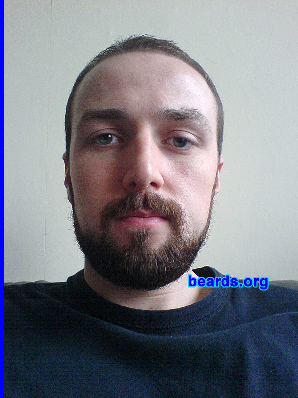Grant
Bearded since: 2009.  I am a dedicated, permanent beard grower.

Comments:
I grew my beard for the first time in August this year, as I became self-employed. Which meant for the first time, I could get away from hearing stupid questions like, "Are you trying to grow a beard?" and, "do you know your beard has ginger in it?".
 
How do I feel about my beard? I like not having to shave everyday. It feels more natural, but I wish my cheeks had more growth. Although, I'm happy enough with what I've got. I give my beard and the top of my head a number four with hair clippers, and shave the sides with a number 3. However, I hope to grow a fuller beard when the cold weather comes.
Keywords: full_beard