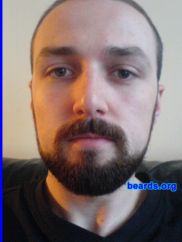 Grant
Bearded since: 2009.  I am a dedicated, permanent beard grower.

Comments:
I grew my beard for the first time in August this year, as I became self-employed. Which meant for the first time, I could get away from hearing stupid questions like, "Are you trying to grow a beard?" and, "do you know your beard has ginger in it?".
 
How do I feel about my beard? I like not having to shave everyday. It feels more natural, but I wish my cheeks had more growth. Although, I'm happy enough with what I've got. I give my beard and the top of my head a number four with hair clippers, and shave the sides with a number 3. However, I hope to grow a fuller beard when the cold weather comes.
Keywords: full_beard