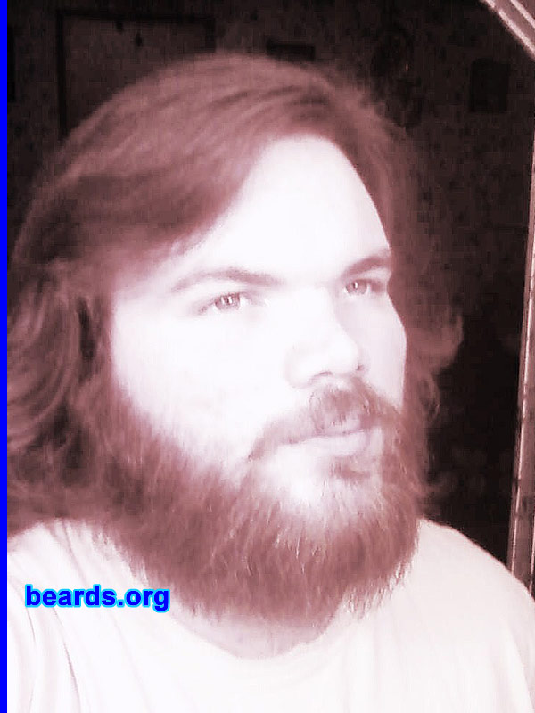David R.
Bearded since: 2004. I am a dedicated, permanent beard grower.

Comments:
Well, I started growing a full goatee when I was thirteen and had a full beard by the time I was fourteen. I've gone clean a couple of times since, but it was only a matter of weeks before I started to grow it back. That's because I figure it's become a part of my image. In a society that views real masculinity as chauvinism it's no surprise metro-sexual fellows are popping up everywhere, carrying around purple hair straighteners & wearing the same types of jeans that our mothers wore back in the '70s. So, at the end of the day, why do I have a beard? Because, simply, that's what a man does, he grows his beard along with chopping wood for a fire built without matches that he's getting ready to use to roast the hand slain bear he just killed somewhere in the middle of nowhere. ;)

How do I feel about my beard? I love my beard. I would be cold and soft without her. 
Keywords: full_beard