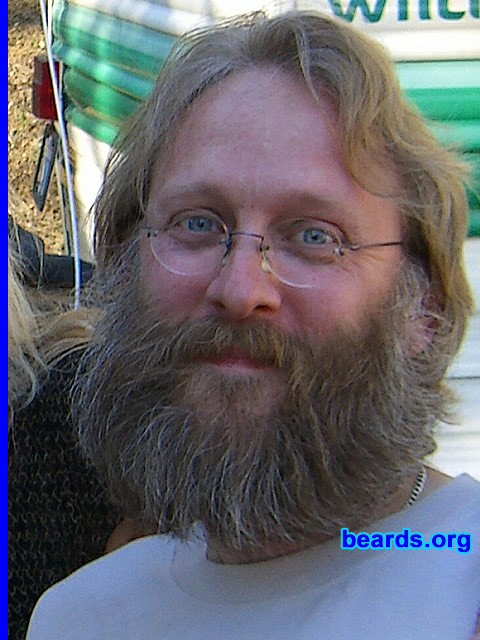 Aarne
Bearded since: 1985.  I am a dedicated, permanent beard grower.

Comments:
Here is my beard in 2003. At 38, it's greying quickly, but I never considered coloring it. This is my minimun length. I will never ever have a shorter beard. Why should I?

How do I feel about my beard?  I enjoyed my beard from day one and always wanted more than I could have. Sometimes there were social pressures, so it would be cut off but only to regrow it right away.
Keywords: full_beard