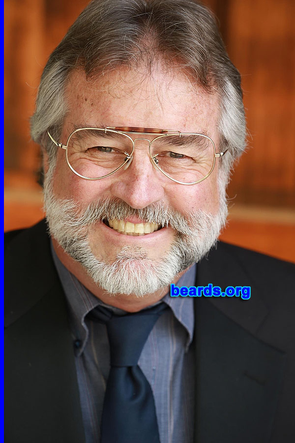 Jeff M.
Bearded since: 1970. I am a dedicated, permanent beard grower.

Comments:
Why did I grow my beard? Because of the desire since reporting aboard my Navy ship during Vietnam Nam war era. Had to stay aboard ship for over a month to satisfy personnel inspection and I.D. requirements.

How do I feel about my beard? It has become my signature feature, ever-evolving as it grays and silvers with its distinctive markings. Shaved off perhaps a half dozen times in the intervening years. Negotiated extra money to shave for a movie that I was involved in. Whilst living in the West Indies, I returned to the island clean shaven after a holiday break. Native Rastafarian greeted me saying "you lose ya strength, mon!"
Keywords: full_beard