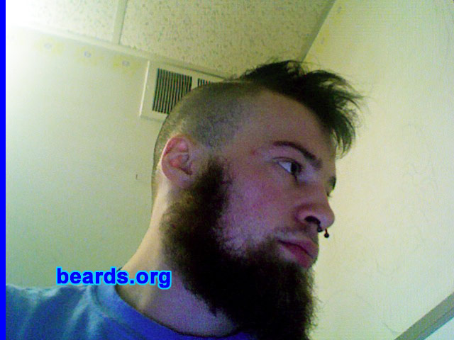 Tyler
Bearded since: 2003.  I am an experimental beard grower.

Comments:
I started growing a beard because I found it unreasonable to carry shaving kits when camping and hiking along the trail. From non-grooming, I started to shave it in different areas, seeing different styles of beards that I could grow. Also, I live in a cold state where a beard is a big plus during the winter.
 
How do I feel about my beard?  I love my beard.  It naturally grows in red, brown, and blonde, and the where the colors are present, never change, as they only grow that color in that area and they fade together over the course of my face. Ever since I have been able to grow a full beard (I was thirteen), I have only been completely shaven two times, but I trim whenever I feel like it.
Keywords: full_beard
