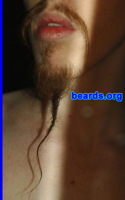 Jacob B.
Bearded since: 2006.  I am a dedicated, permanent beard grower.

Comments:
Why did I grow my beard? I had wanted to for quite some time, seeing my father with a full beard my entire childhood, but I had very sparse and slow growing facial hair. One summer I finally felt like I had enough coverage, at least on my lip and chin, to start growing out.

As a secondary sexual characteristic, beards represent manhood. Having facial hair certainly helped to lessen the previously numerous times I would be confused with a woman for my long hair (and short stature of 5'4").

How do I feel about my beard? I feel my beard is truly a part of me. I've been told that my beard seems tailored for my face and personality in a way people don't normally see. I think it has to do with the fact that for the most part I don't do anything to maintain the "style" I carry other than shaving off the floating mutton chops on my cheeks and twisting the ends of my "fu" to keep individual hairs out of my mouth while eating and twisting the end of my "mandarin" goatee to keep the longer hairs from getting pulled out.

How do I feel about my beard?  I love it!
Keywords: goatee_mustache
