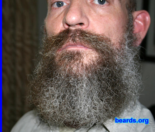 Johan v.d.W.
Bearded since: 2007.  I am a dedicated, permanent beard grower.

Comments:
I never thought I'd have a full beard.  The idea just never appealed to me, though my father had a goatee at times. I did always hate shaving, though. I stopped shaving at the age of twenty-five, and since then have always had stubble of varying degrees on my face, which I kept short with a beard trimmer. While on holiday in December 2007, I stopped trimming and received such positive comments that I decided to let it grow. I will never again trim, shave or cut any part of my beard.

How do I feel about my beard?  I love it. It looks good.  It feels good. It's natural. I really like the way it's graying with dark bands extending down from the mustache, which also hasn't turned gray. It's a year now and I'm curious to see how long it'll get.
Keywords: full_beard